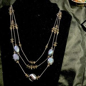 Dark gray necklace with glass and plastic beats.